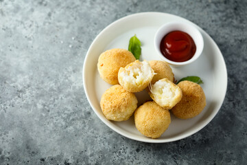 Traditional homemade arancini balls with tomato sauce	