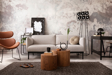 The stylish compostion at living room interior with design gray sofa, wooden coffee table, desk and...