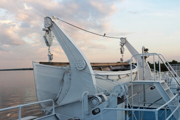 lifeboat on the boat deck of the ship at sunset
