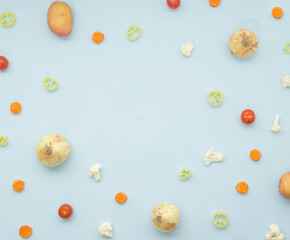 Fresh vegetables on blue pastel background. Top view with copy space. Healthy eating concept.
