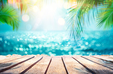 Summer Table And Sea With  Blurred Leaves Palm And Defocused Bokeh Light On Ocean - Wooden Plank In...