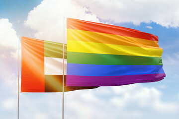 Sunny blue sky and flags of lgbt and uae