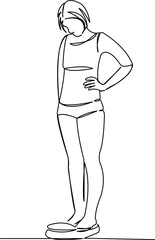 Fototapeta premium girl weighing herself on the scales