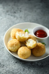 Traditional homemade arancini balls with tomato sauce	