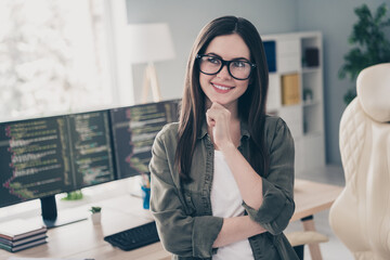 Portrait of attractive cheerful girl making decision web development company thinking at workplace workstation indoors