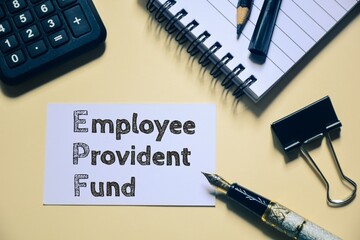 Employee Provident Fund text is shown on white card with stationery items on office desk.  
