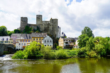 Fototapeta na wymiar Runkel Castle in Runkel. Old castle on the Lahn with an old stone bridge. Landscape by the river with historic buildings. 