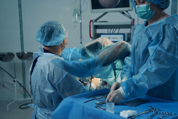 Woman with covered legs undergoing hysteroscopy in clinic