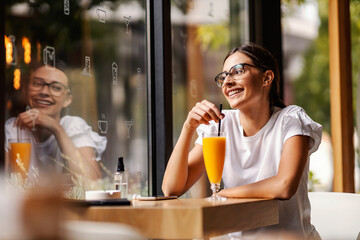 A woman in a bar drinking juice
