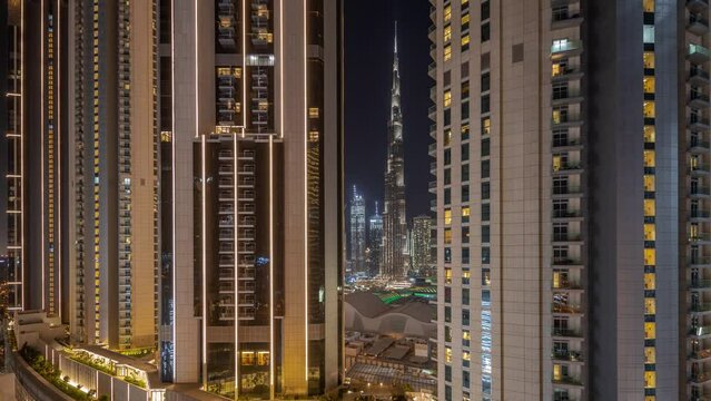 Panorama Showing Tallest Skyscrapers During Earth Hour In Downtown Dubai Located On Bouleward Street Near Shopping Mall Aerial Night Timelapse. Lights And Illumination Turning On After One Hour