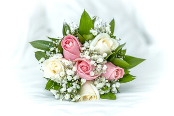 Bouquet of white and pink roses on the bed on the wedding day
