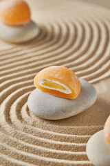 Fototapeta na wymiar Japanese mochi cake on a sandy summer background
