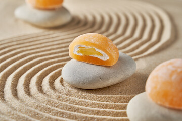 Japanese mochi cake on a sandy summer background