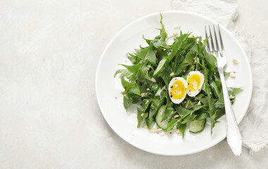 Fresh dandelion salad on light background.
