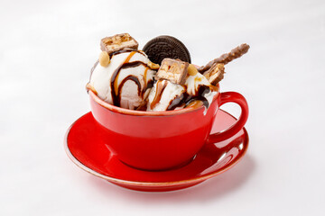 Chocolate and hazelnut ice cream and topping on a white background