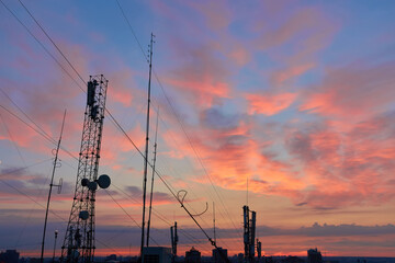 Fototapeta na wymiar televisions antennas with sunset cloudy sky