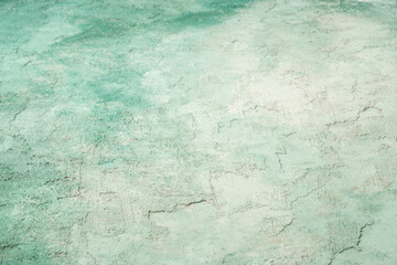 textured and aged old wall painted green and white