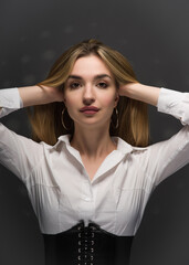Fototapeta premium Portrait of a young blonde straightening her hair