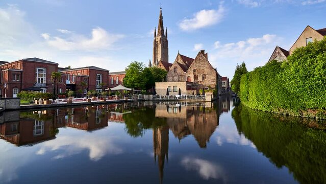 Bruges timelapse showing the Bakkersrei canal and the spire of the Church of Our Lady (Onze Lieve Vrouw). Belgium