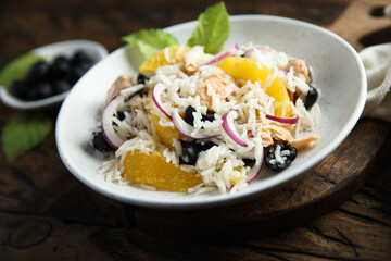 Healthy rice salad with orange and salmon