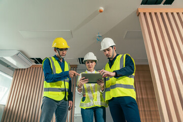 Engineer and architect working discussion plan in construction process interior with augmented reality technology on digital tablet. Concept technology in construction business.