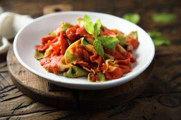 Multi colored pasta with tomato and basil