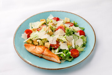 Grilled shrimp and salmon salad on a white background