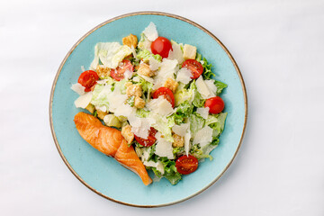 Grilled shrimp and salmon salad on a white background