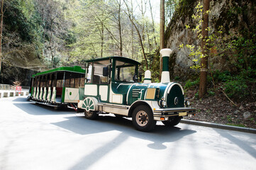 Train excursion at Punkva Caves outdoor near rocks, Czech Republic.