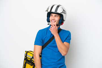 Young caucasian man with thermal backpack isolated on white background looking to the side