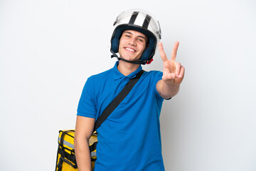 Young caucasian man with thermal backpack isolated on white background smiling and showing victory sign