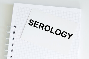 Serology text card on a notebook that sits on a light desk, a medical concept