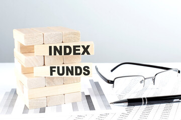 INDEX FUNDS is written on wooden blocks on a chart background