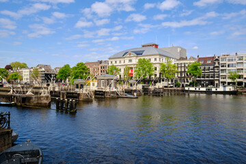 Amsterdam, Netherlands, 11 May 2022 - Panoramic.View of the Amstel river and the city skyline. Blue skies in spring sunshine.