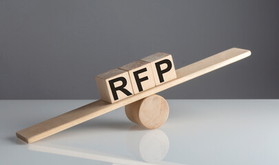 RFP on wooden cubes on a wooden balance , business concept