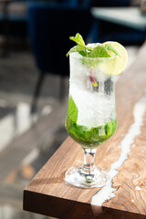 Lemonade or mojito cocktail with lemon and mint, cold refreshing drink or drink with ice.