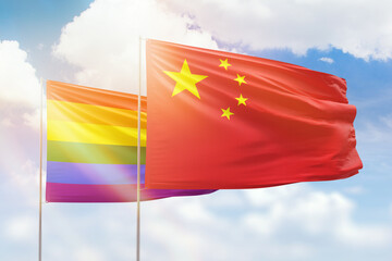 Sunny blue sky and flags of lgbt and china