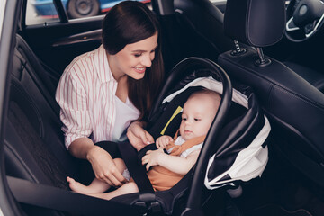 Photo of cheerful positive mom son wear casual outfits sitting transport fasten seatbelt inside...