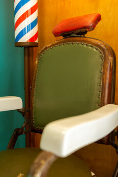 antique barber chair with barbel pole sign
