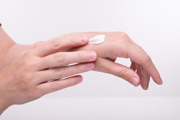 Women's hands that smear hand cream