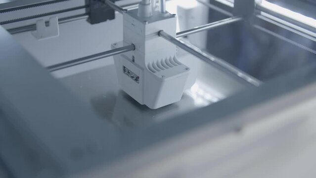 3D Printer in the process of manufacturing a new object from a digital render
