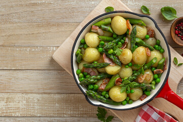 One-pan roasted baby potatoes with asparagus, bacon and peas