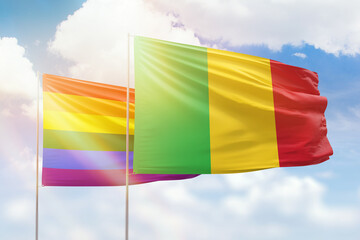 Sunny blue sky and flags of lgbt and mali