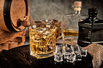 Glasses of whiskey with ice in a rustic setting