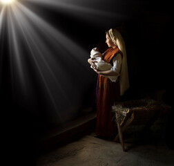 Mary in the stable near the manger with the baby - obrazy, fototapety, plakaty