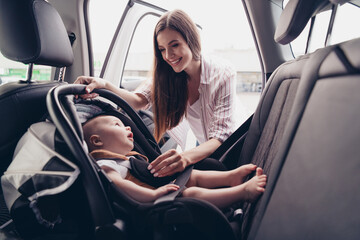 Photo of peaceful satisfied mommy cute charming toddler sitting safety chair auto spend weekend...
