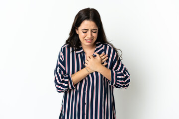 Young caucasian woman over isolated background having a pain in the heart