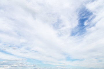 Obraz premium Beautiful soft gentle cloudy blue sky with many white cirrus and fluffy clouds, abstract background texture, heaven 