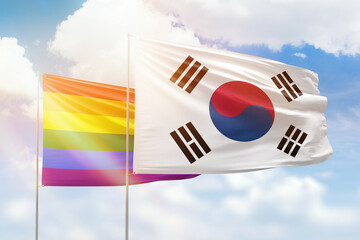 Sunny blue sky and flags of lgbt and south korea