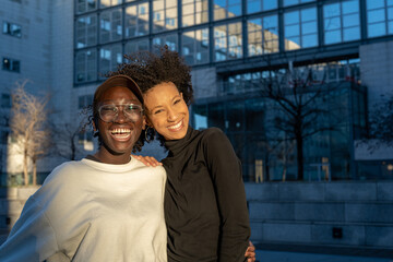 urban portrait of two young African American women, smiling friends, mutiracial group, lgbt couple, diversity concept, copy space
